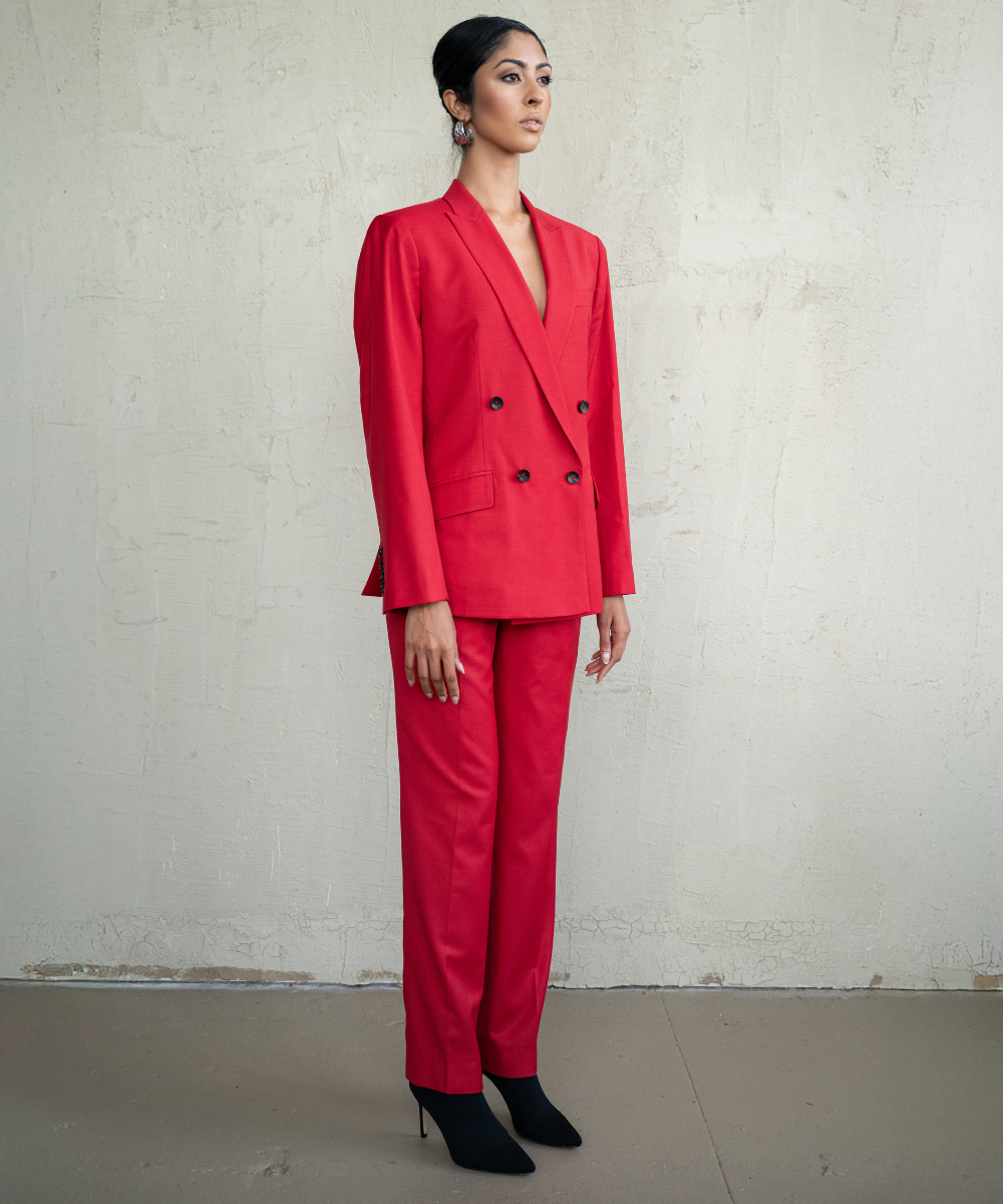 Person wearing a red suit against a plain background